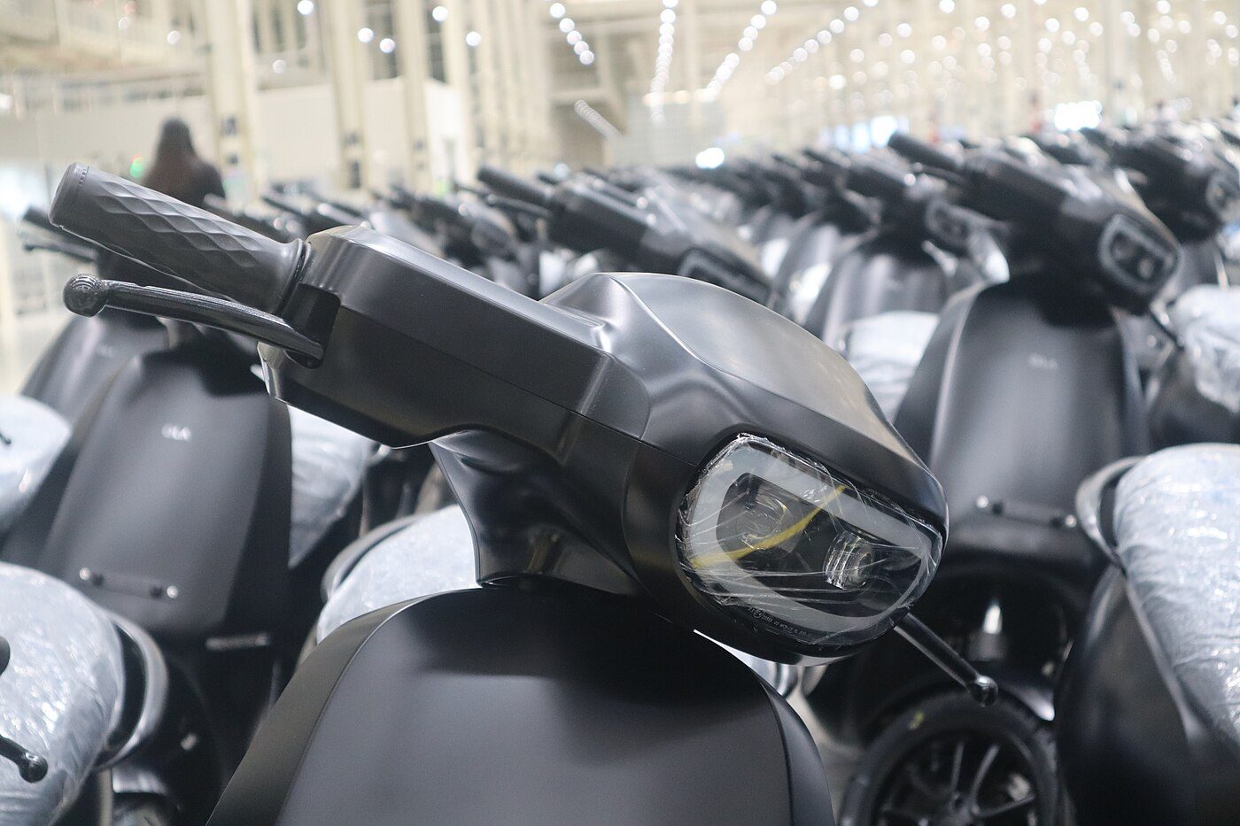 Black electric scooters at a showroom