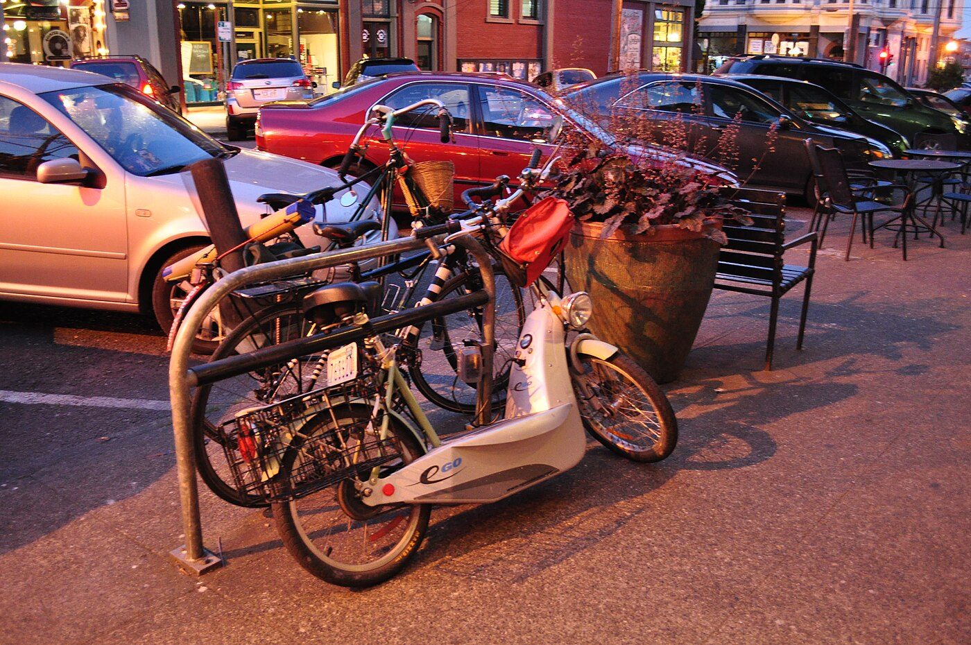 Electric scooter charging at curbside